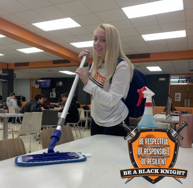 Student helping to wash tables